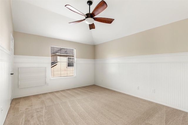 7127 Vermejo Park Ln, Humble, TX 77346 - empty room with a ceiling fan, light colored carpet, a wainscoted wall, and lofted ceiling