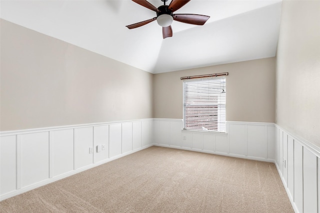 7127 Vermejo Park Ln, Humble, TX 77346 - unfurnished room with ceiling fan, light carpet, vaulted ceiling, a wainscoted wall, and a decorative wall