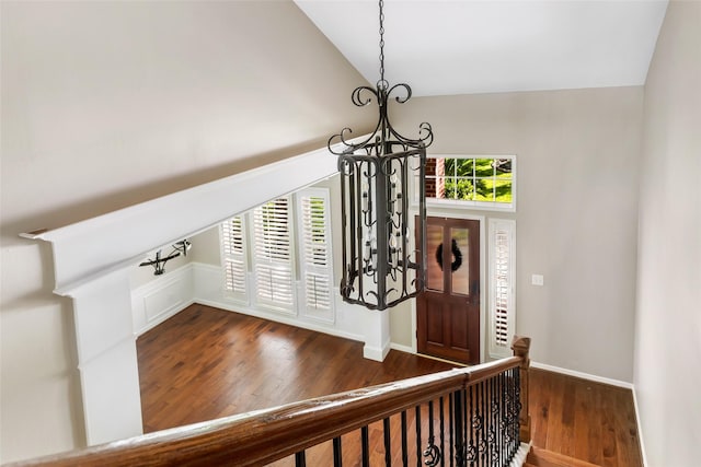 7127 Vermejo Park Ln, Humble, TX 77346 - entryway featuring a chandelier, vaulted ceiling, and dark wood-type flooring