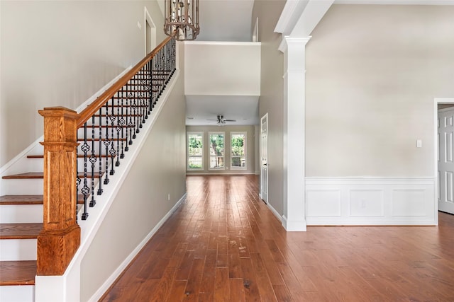 7127 Vermejo Park Ln, Humble, TX 77346 - entrance foyer with wood finished floors, ceiling fan, stairs, a high ceiling, and ornate columns