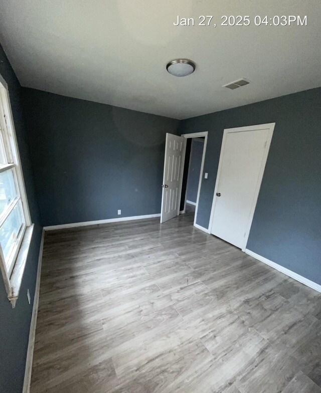 2212 Rugeley St, Bay City, TX 77414 - unfurnished bedroom with baseboards and wood finished floors