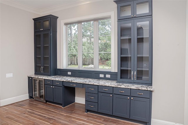 1530 Cunningham Parc Ln, Houston, TX 77055 - kitchen featuring wine cooler, dark wood-type flooring, light stone counters, glass insert cabinets, and crown molding