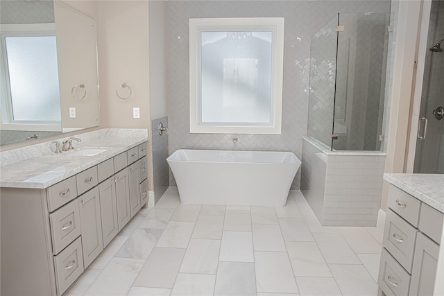 1530 Cunningham Parc Ln, Houston, TX 77055 - full bathroom featuring plenty of natural light, vanity, a shower stall, a soaking tub, and tile walls