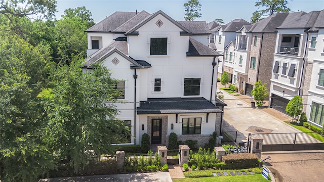 1530 Cunningham Parc Ln, Houston, TX 77055 - french country inspired facade featuring a gate, stucco siding, a fenced front yard, and roof with shingles