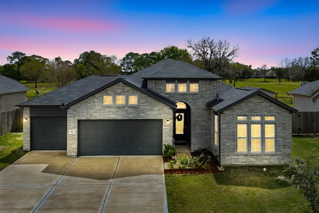 541 Green Meadows Dr, West Columbia, TX 77486 - view of front of home with driveway, an attached garage, and brick siding