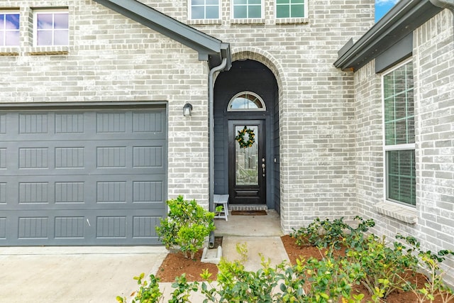 541 Green Meadows Dr, West Columbia, TX 77486 - entrance to property featuring concrete driveway, an attached garage, and brick siding