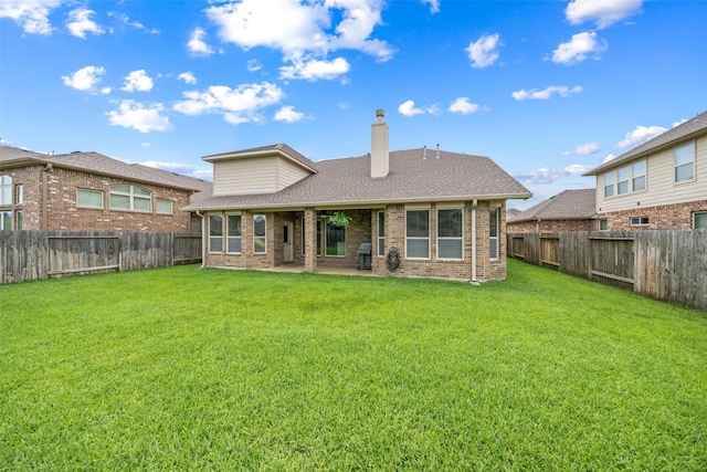 10002 Mahaffey Rd, Tomball, TX 77375 - back of house featuring a chimney, a fenced backyard, brick siding, and roof with shingles
