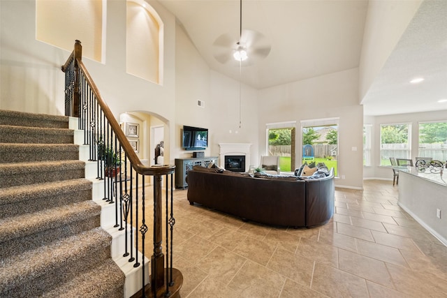 10002 Mahaffey Rd, Tomball, TX 77375 - living room with a ceiling fan, a glass covered fireplace, stairway, a towering ceiling, and recessed lighting