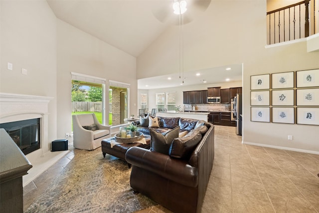 10002 Mahaffey Rd, Tomball, TX 77375 - living area featuring high vaulted ceiling, a glass covered fireplace, ceiling fan, light tile patterned floors, and recessed lighting