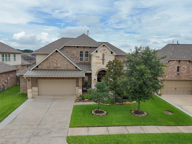 10002 Mahaffey Rd, Tomball, TX 77375 - french country home featuring concrete driveway, a standing seam roof, a shingled roof, stone siding, and a front lawn
