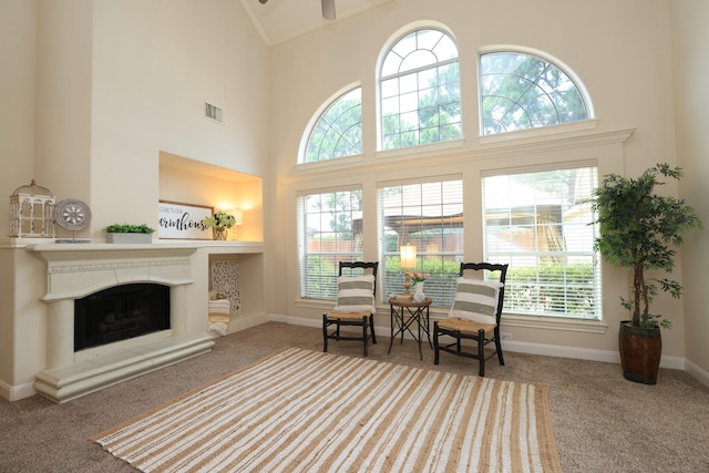 17430 Autumn Oak Way, Spring, TX 77379 - sitting room featuring carpet, high vaulted ceiling, a fireplace with raised hearth, and ceiling fan