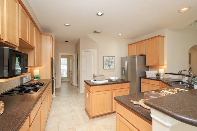 17430 Autumn Oak Way, Spring, TX 77379 - kitchen with light brown cabinetry, stainless steel fridge, stovetop with downdraft, black microwave, and a kitchen island