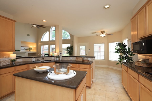 17430 Autumn Oak Way, Spring, TX 77379 - kitchen featuring black microwave, ceiling fan, a kitchen island, light tile patterned flooring, and recessed lighting