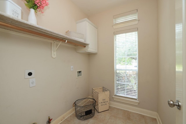 17430 Autumn Oak Way, Spring, TX 77379 - washroom with washer hookup, cabinet space, hookup for an electric dryer, light tile patterned floors, and healthy amount of natural light