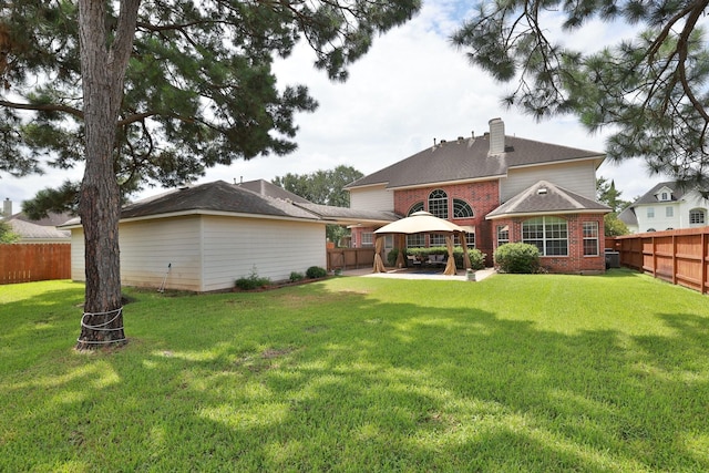 17430 Autumn Oak Way, Spring, TX 77379 - rear view of house with a gazebo, a fenced backyard, brick siding, a chimney, and a patio
