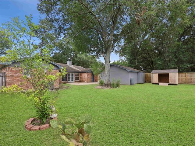 1135 Ivy Ln, Beaumont, TX 77706 - view of yard with a storage shed and french doors