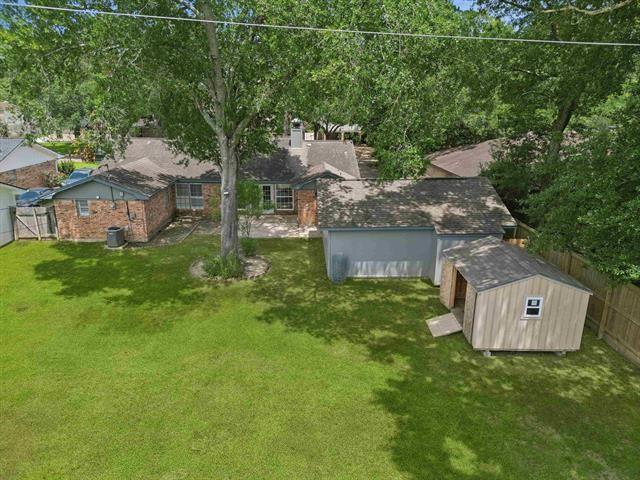 1135 Ivy Ln, Beaumont, TX 77706 - fenced backyard with a storage shed
