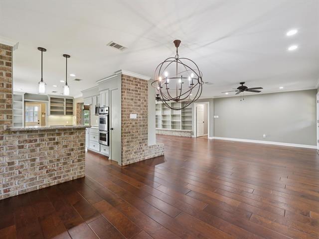 1135 Ivy Ln, Beaumont, TX 77706 - unfurnished living room featuring a chandelier, dark wood-type flooring, recessed lighting, and ceiling fan