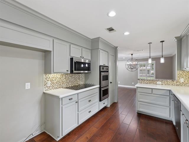 1135 Ivy Ln, Beaumont, TX 77706 - kitchen with appliances with stainless steel finishes, recessed lighting, backsplash, a chandelier, and pendant lighting