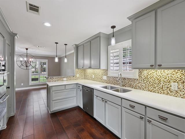 1135 Ivy Ln, Beaumont, TX 77706 - kitchen featuring dishwasher, gray cabinets, crown molding, a peninsula, and decorative light fixtures