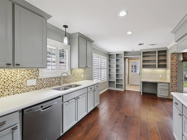 1135 Ivy Ln, Beaumont, TX 77706 - kitchen featuring dishwasher, gray cabinets, decorative backsplash, light countertops, and dark wood-style floors