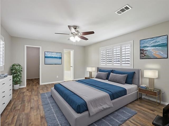 1135 Ivy Ln, Beaumont, TX 77706 - bedroom with wood finished floors, a walk in closet, a ceiling fan, and connected bathroom