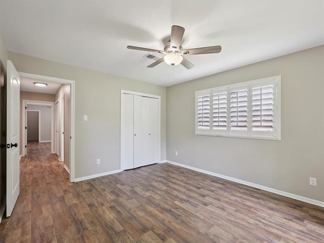 1135 Ivy Ln, Beaumont, TX 77706 - unfurnished bedroom with a closet, wood finished floors, and a ceiling fan