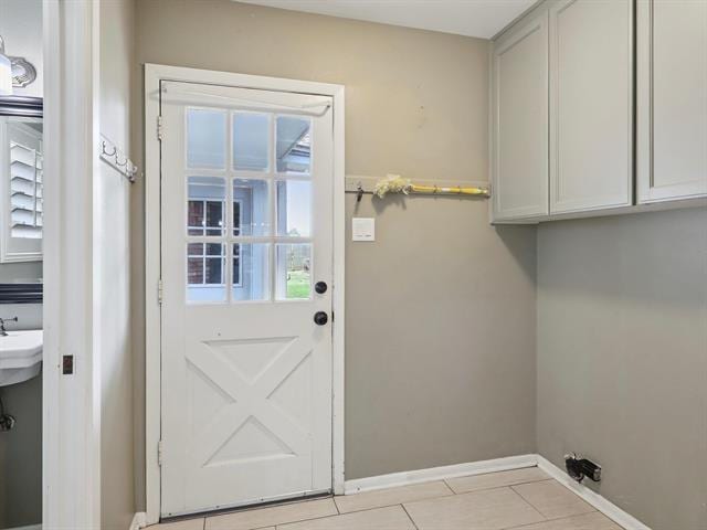 1135 Ivy Ln, Beaumont, TX 77706 - washroom featuring cabinet space and light tile patterned floors