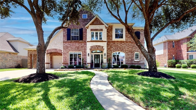 26635 Godfrey Cove Ct, Katy, TX 77494 - view of front of house with a front yard, brick siding, driveway, and a garage