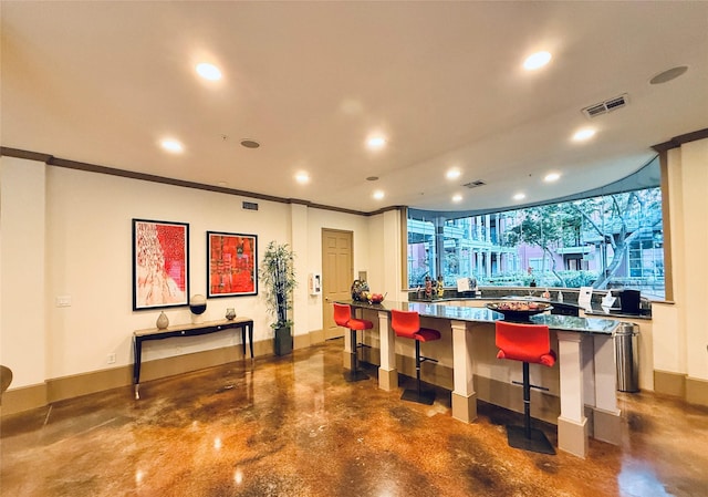 2400 Mccue Rd Unit 345, Houston, TX 77056 - bar area with finished concrete flooring, crown molding, and recessed lighting