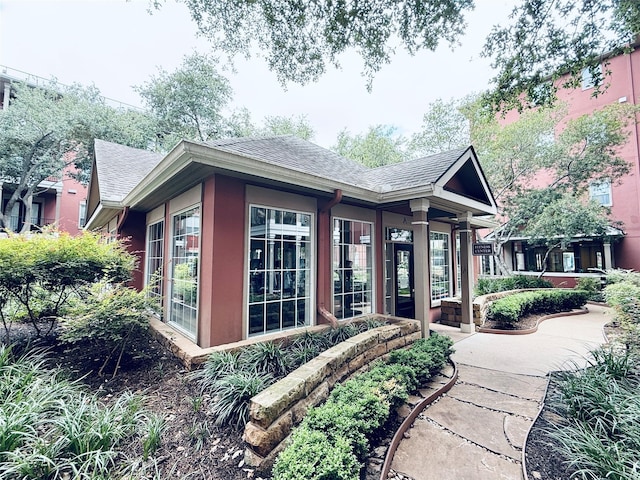 2400 Mccue Rd Unit 345, Houston, TX 77056 - view of front of home featuring a shingled roof and stucco siding