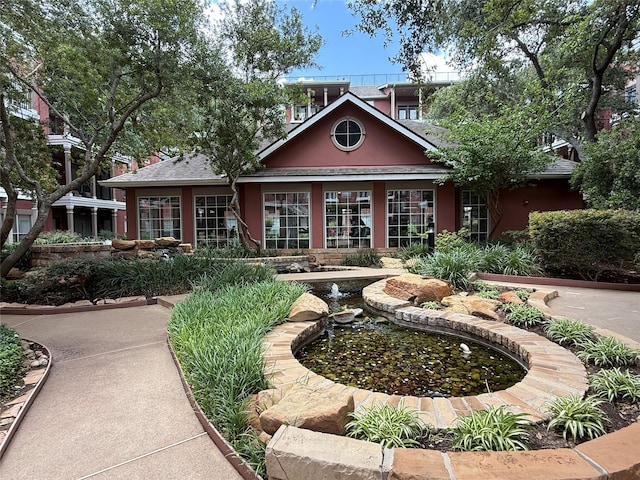 2400 Mccue Rd Unit 345, Houston, TX 77056 - back of property featuring stucco siding and a small pond