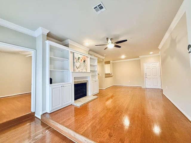 2400 Mccue Rd Unit 345, Houston, TX 77056 - unfurnished living room featuring ceiling fan, light wood-type flooring, ornamental molding, a fireplace with raised hearth, and recessed lighting