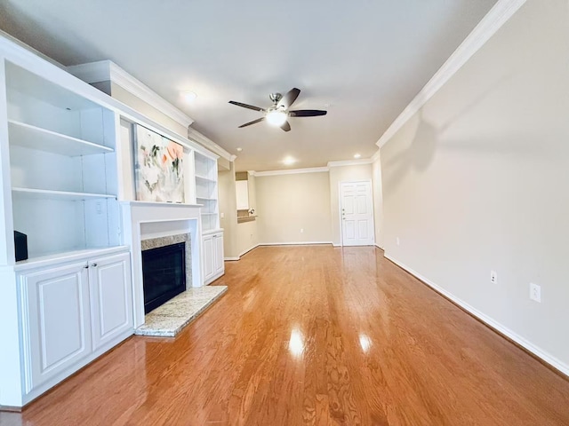 2400 Mccue Rd Unit 345, Houston, TX 77056 - unfurnished living room with ceiling fan, crown molding, a fireplace with raised hearth, light wood-type flooring, and recessed lighting