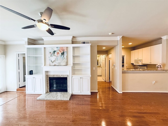 2400 Mccue Rd Unit 345, Houston, TX 77056 - unfurnished living room with ornamental molding, wood finished floors, ceiling fan, a high end fireplace, and recessed lighting