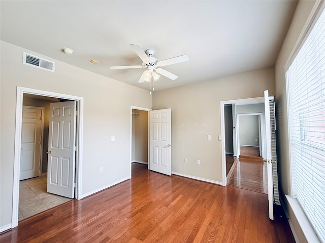 2400 Mccue Rd Unit 345, Houston, TX 77056 - unfurnished bedroom with light wood-type flooring and a ceiling fan