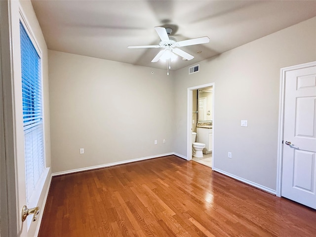 2400 Mccue Rd Unit 345, Houston, TX 77056 - unfurnished bedroom with wood finished floors, ensuite bathroom, and a ceiling fan
