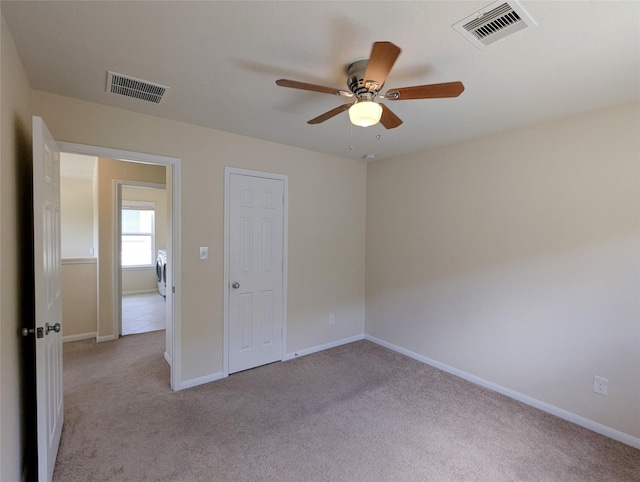 7206 Sunburst Meadow Dr, Houston, TX 77083 - unfurnished room with a ceiling fan, light colored carpet, and washer / dryer