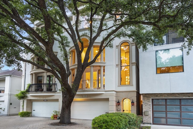 6506 Rodrigo St, Houston, TX 77007 - view of front of home with a garage, stucco siding, stone siding, and driveway