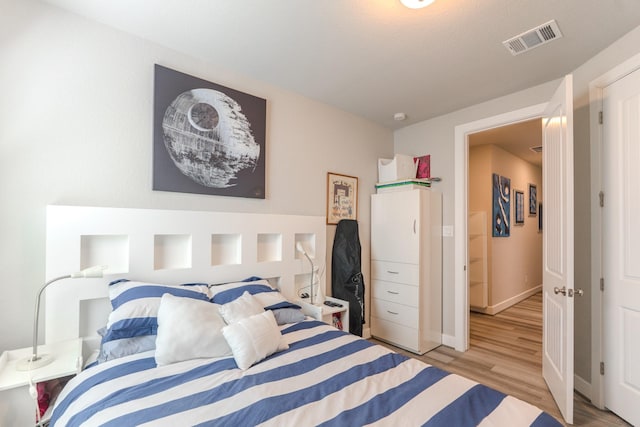40 Snowdrop Lily Dr, Tomball, TX 77375 - bedroom featuring light wood-style flooring and baseboards