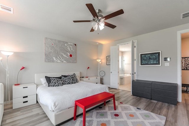 40 Snowdrop Lily Dr, Tomball, TX 77375 - bedroom with wood finished floors, ensuite bath, and ceiling fan