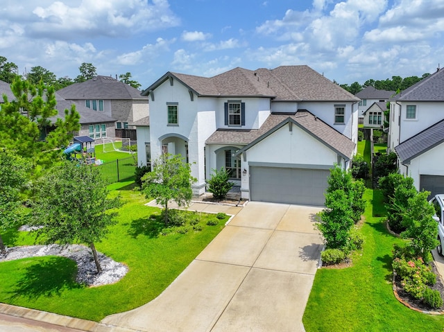 40 Snowdrop Lily Dr, Tomball, TX 77375 - french country inspired facade with stucco siding, concrete driveway, a residential view, a garage, and roof with shingles