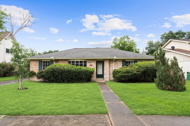 9310 Carvel Ln, Houston, TX 77036 - view of front facade with a front lawn, brick siding, and roof with shingles