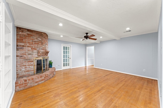 9310 Carvel Ln, Houston, TX 77036 - unfurnished living room featuring beamed ceiling, a brick fireplace, light wood-type flooring, ceiling fan, and recessed lighting