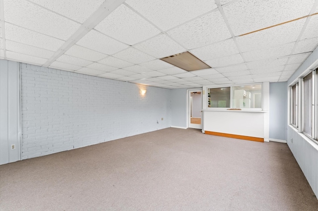 9310 Carvel Ln, Houston, TX 77036 - below grade area featuring brick wall, carpet, and a drop ceiling