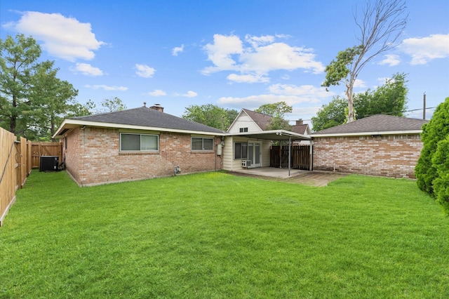 9310 Carvel Ln, Houston, TX 77036 - back of property with a patio area, brick siding, a fenced backyard, a chimney, and a shingled roof