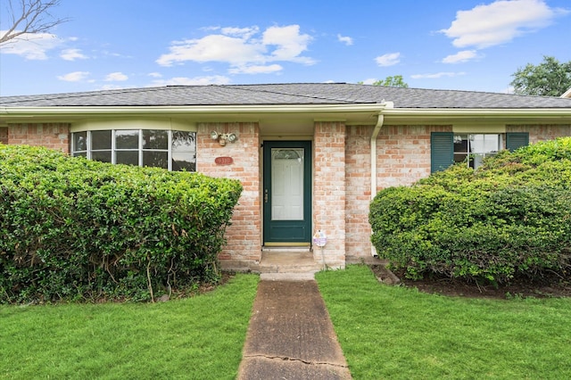 9310 Carvel Ln, Houston, TX 77036 - view of front of house with a front yard, a shingled roof, and brick siding