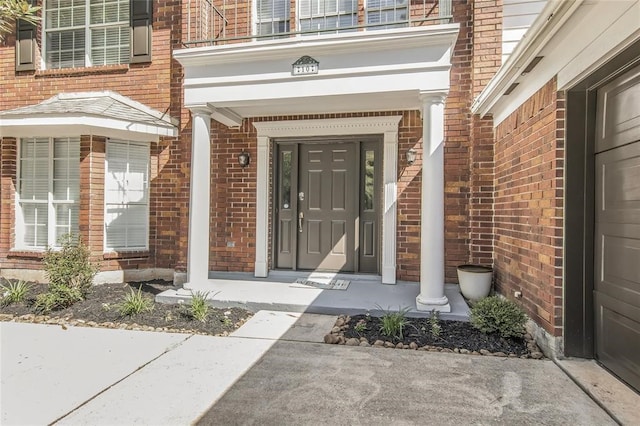10 Elk Crossing Dr, The Woodlands, TX 77381 - doorway to property with brick siding and a porch