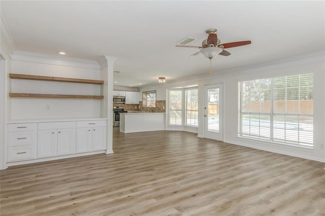 10 Elk Crossing Dr, The Woodlands, TX 77381 - unfurnished living room with crown molding, a ceiling fan, plenty of natural light, recessed lighting, and light wood-style flooring