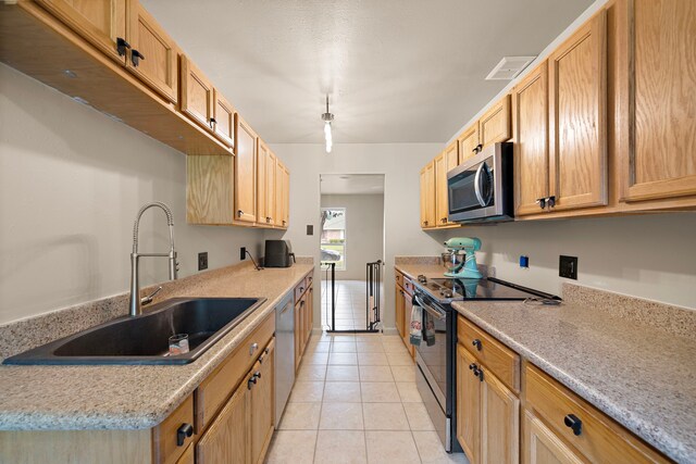 741 Rutgers Ln, Deer Park, TX 77536 - kitchen with stainless steel appliances, light tile patterned floors, and light countertops